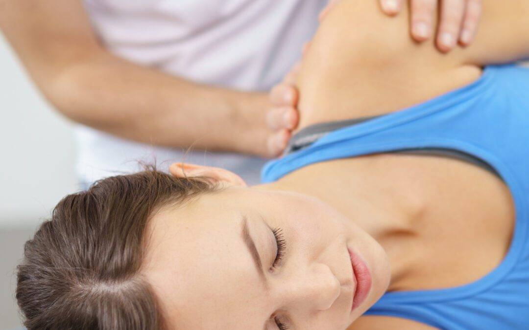 Woman Lying on Bed While Having Shoulder Massage