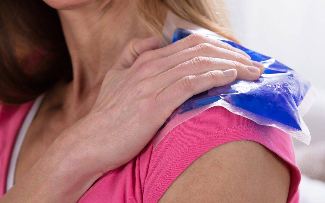 Woman Applying Ice Bag On Her Shoulder