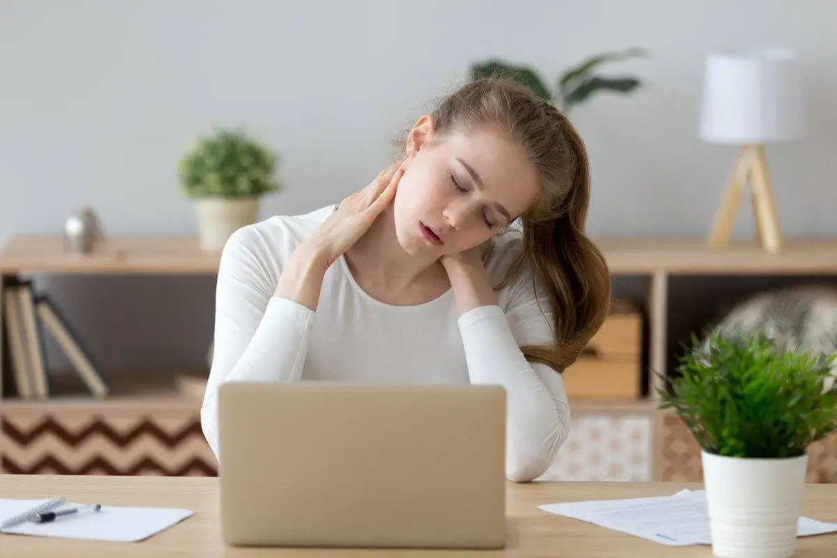 Tired girl massaging neck suffering from back pain