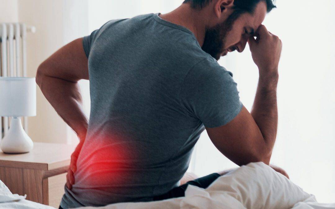 Man waking up in the morning and suffer for back pain