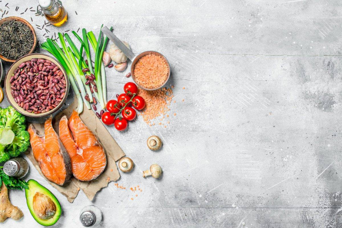 Organic food. Assortment of heathy food with raw salmon steaks .