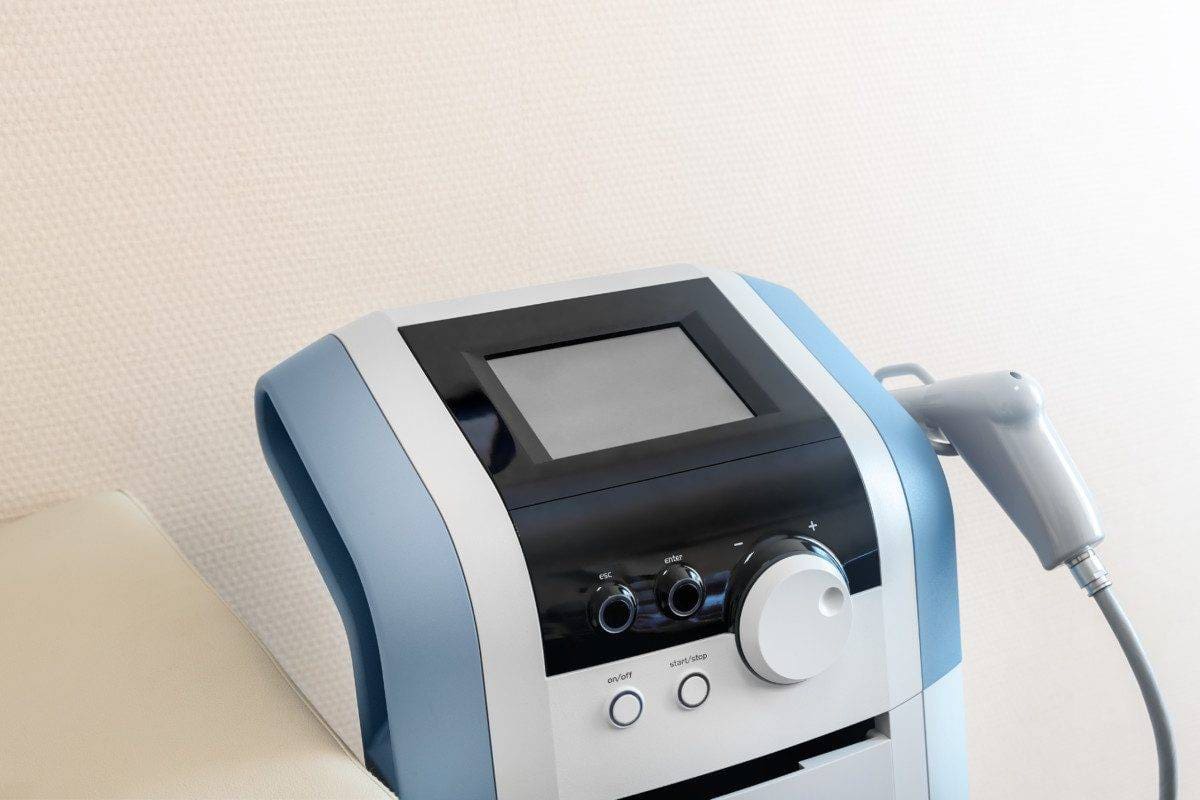 Closeup detail view of modern extracorporeal shock wave ultrasound eswt treatment equipment medical office. Physiotherapy rehabilitation and treatment. Healthcare device and technology
