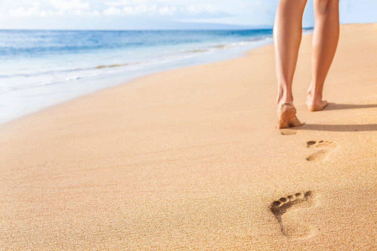Beach sand footprints woman legs walking relaxing