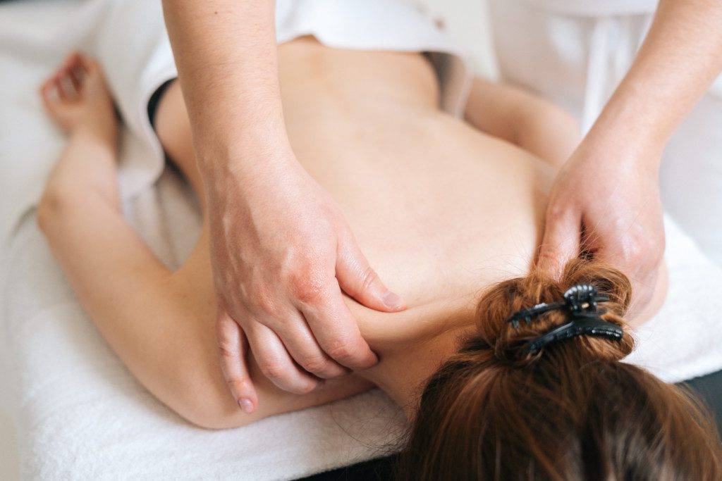 a woman getting a massage in a spa