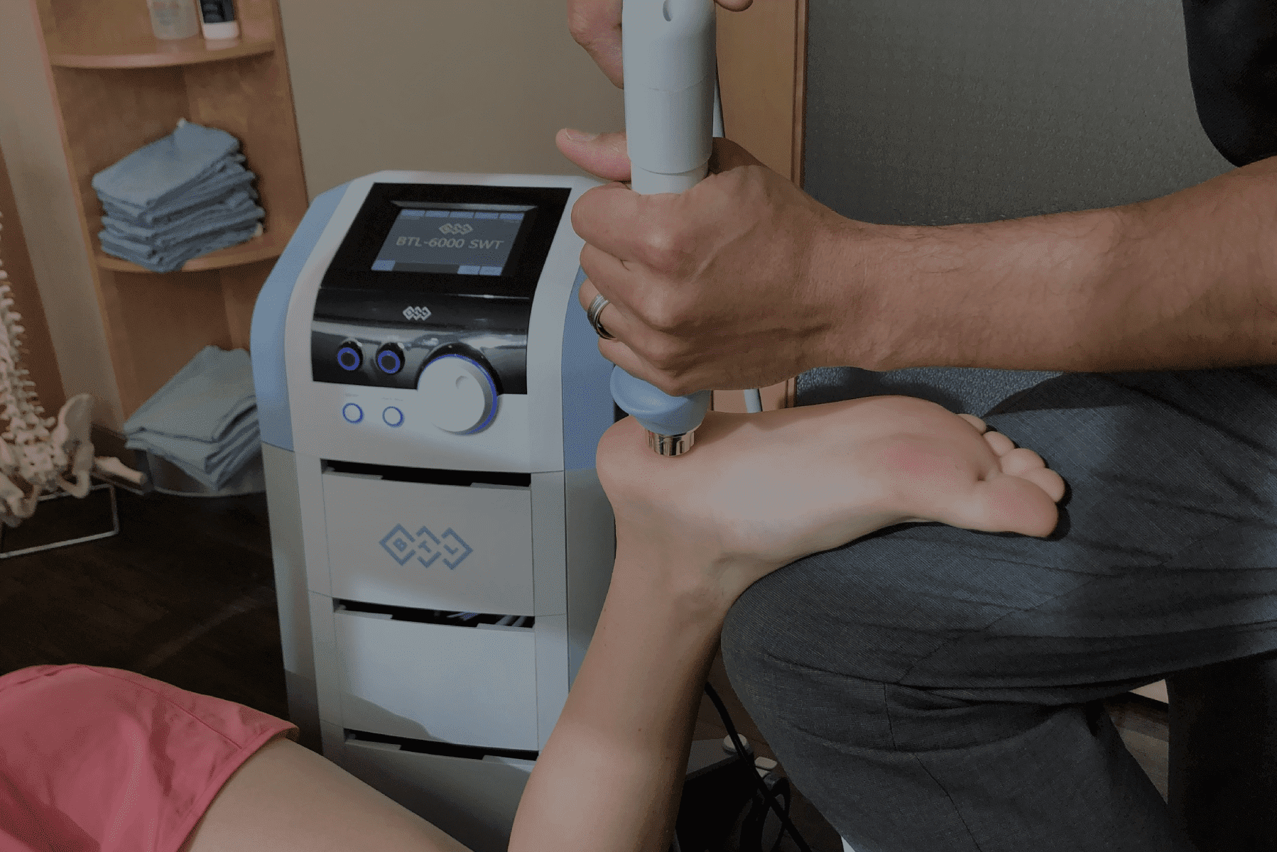 a woman is getting her foot massaged by a machine
