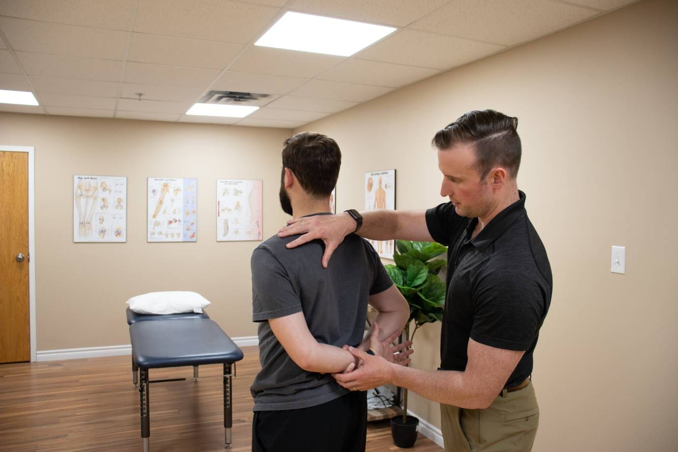 a man is getting his back adjusted in a room
