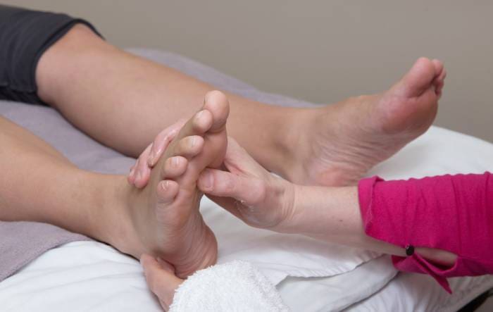 a woman getting a foot massage in a hospital