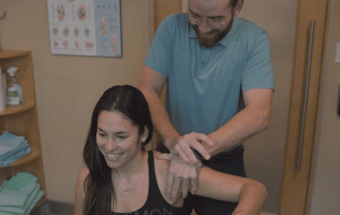 a woman is getting a massage from a man
